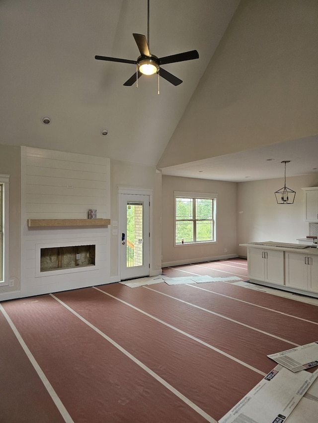 2895 Cooper Creek Rd, Woodlawn, TN 37191 - unfurnished living room featuring a glass covered fireplace, a ceiling fan, and high vaulted ceiling