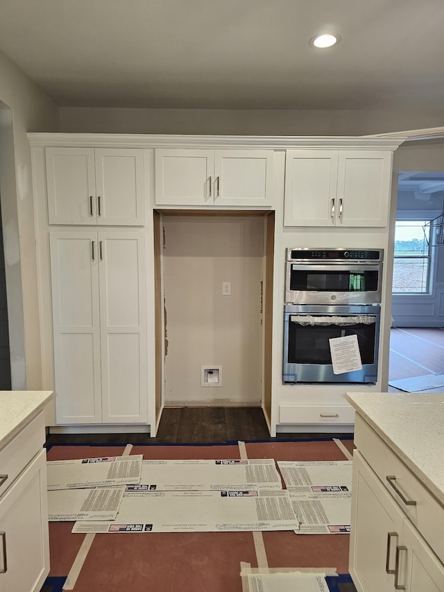 2895 Cooper Creek Rd, Woodlawn, TN 37191 - kitchen with white cabinetry, recessed lighting, stainless steel double oven, and dark wood finished floors