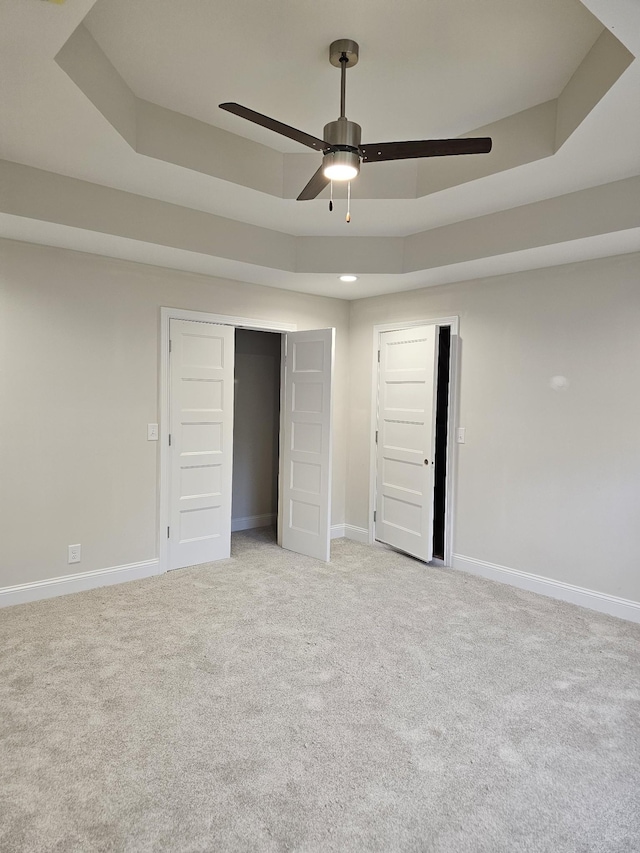 2895 Cooper Creek Rd, Woodlawn, TN 37191 - unfurnished bedroom with a tray ceiling, light colored carpet, a ceiling fan, and a closet