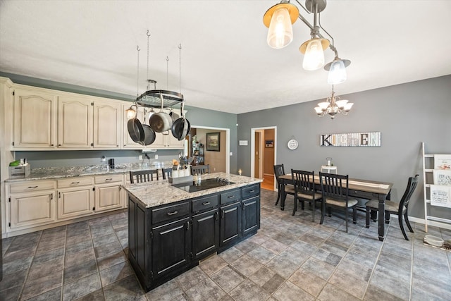 5546 Old Kentucky Rd, Byrdstown, TN 38549 - kitchen featuring cream cabinetry, a chandelier, dark cabinetry, and stone finish flooring