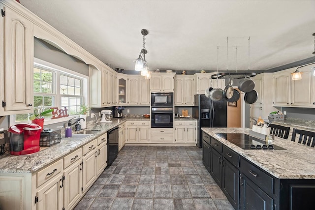5546 Old Kentucky Rd, Byrdstown, TN 38549 - kitchen with black appliances, dark cabinetry, cream cabinetry, stone finish flooring, and pendant lighting
