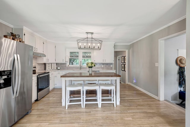 1519 Graybar Ln, Murfreesboro, TN 37129 - kitchen featuring appliances with stainless steel finishes, under cabinet range hood, white cabinetry, tasteful backsplash, and ornamental molding