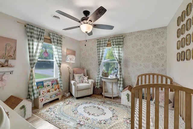 1519 Graybar Ln, Murfreesboro, TN 37129 - bedroom featuring a crib and a ceiling fan
