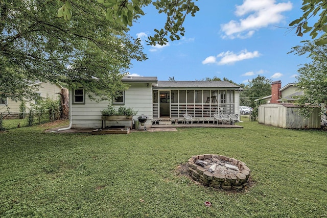 1519 Graybar Ln, Murfreesboro, TN 37129 - rear view of property featuring a storage shed, a sunroom, and a fire pit