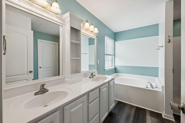 7607 Birdsong Ct, Fairview, TN 37062 - bathroom featuring a bath, double vanity, and wood finished floors