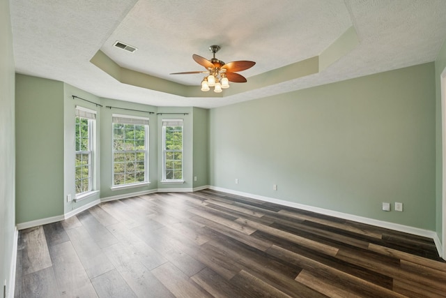 7607 Birdsong Ct, Fairview, TN 37062 - empty room with a tray ceiling, a textured ceiling, ceiling fan, and dark wood finished floors