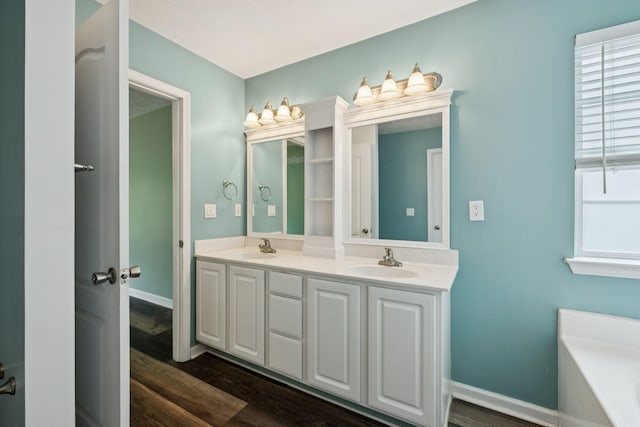 7607 Birdsong Ct, Fairview, TN 37062 - bathroom with double vanity, a bath, wood finished floors, and plenty of natural light