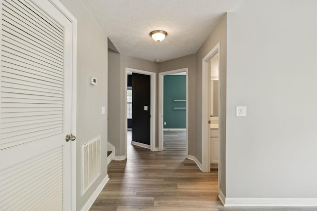 7607 Birdsong Ct, Fairview, TN 37062 - corridor featuring wood finished floors and a textured ceiling