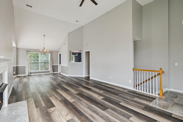 7607 Birdsong Ct, Fairview, TN 37062 - unfurnished living room with high vaulted ceiling, a chandelier, a ceiling fan, a fireplace with flush hearth, and wood finished floors