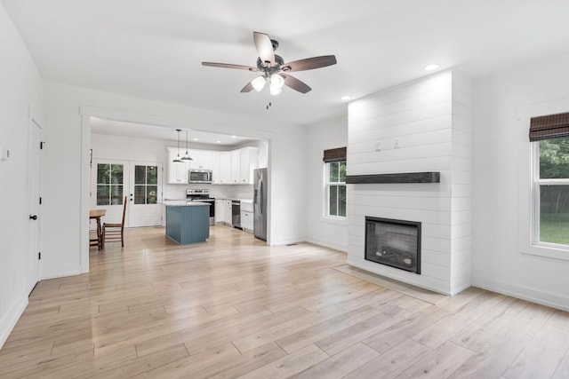 4486 Beards Chapel Rd, Springfield, TN 37172 - unfurnished living room featuring a ceiling fan, light wood-style flooring, recessed lighting, and a large fireplace