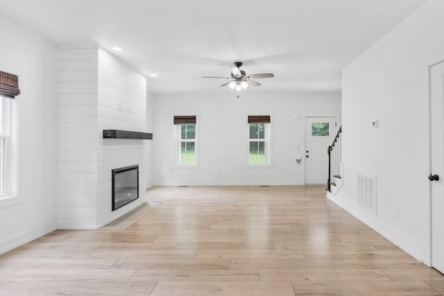 4486 Beards Chapel Rd, Springfield, TN 37172 - unfurnished living room with stairs, ceiling fan, a large fireplace, light wood-type flooring, and recessed lighting