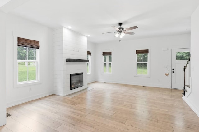 4486 Beards Chapel Rd, Springfield, TN 37172 - unfurnished living room featuring stairs, a large fireplace, ceiling fan, recessed lighting, and light wood-type flooring