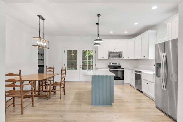 4486 Beards Chapel Rd, Springfield, TN 37172 - kitchen featuring appliances with stainless steel finishes, a center island, light wood-style flooring, white cabinets, and recessed lighting