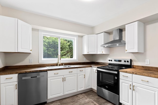 610 Maple Ln, Chattanooga, TN 37411 - kitchen with stainless steel appliances, wall chimney exhaust hood, butcher block countertops, and white cabinetry