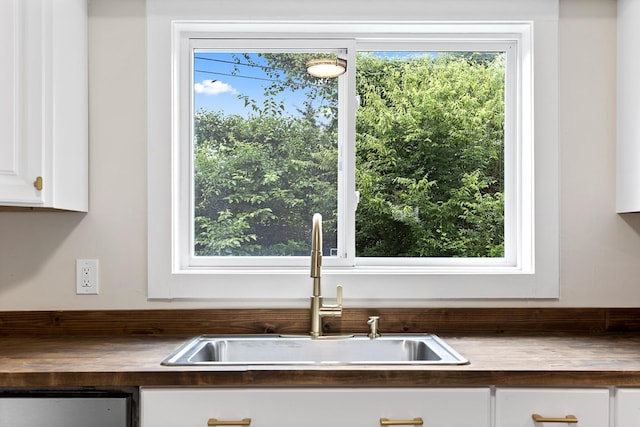610 Maple Ln, Chattanooga, TN 37411 - kitchen with white cabinetry, wooden counters, and dishwashing machine