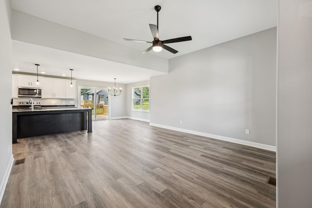 578 Oak Glen Dr, Smithville, TN 37166 - unfurnished living room with a chandelier, dark wood-style floors, and a ceiling fan