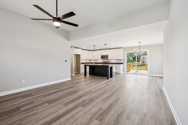 578 Oak Glen Dr, Smithville, TN 37166 - unfurnished living room with wood finished floors, a chandelier, recessed lighting, and a ceiling fan
