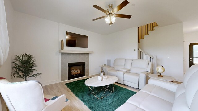 220 Young Ln, Pleasant View, TN 37146 - living area featuring stairs, wood finished floors, ceiling fan, and a fireplace