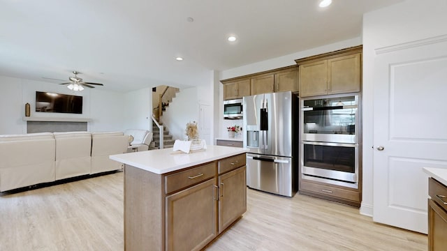 220 Young Ln, Pleasant View, TN 37146 - kitchen with stainless steel appliances, light wood-style flooring, a kitchen island, a ceiling fan, and recessed lighting