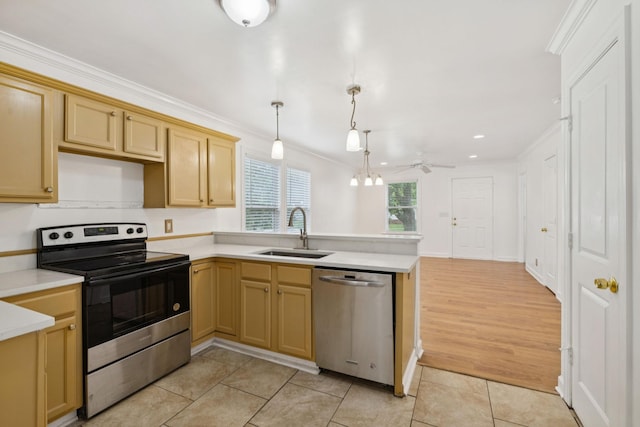 354 9th Ave N, Franklin, TN 37064 - kitchen with stainless steel appliances, crown molding, a peninsula, light countertops, and light tile patterned floors