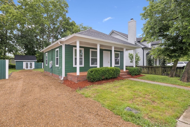 354 9th Ave N, Franklin, TN 37064 - view of front of home featuring french doors, a chimney, a porch, and an outbuilding