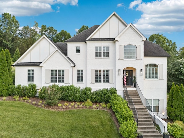 6342 Panorama Dr, Brentwood, TN 37027 - view of front of house with board and batten siding, stairs, a front yard, brick siding, and roof with shingles