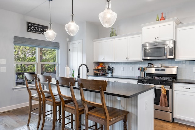 5308 Abbottswood Dr, Smyrna, TN 37167 - kitchen with stainless steel appliances, tasteful backsplash, dark countertops, and white cabinetry