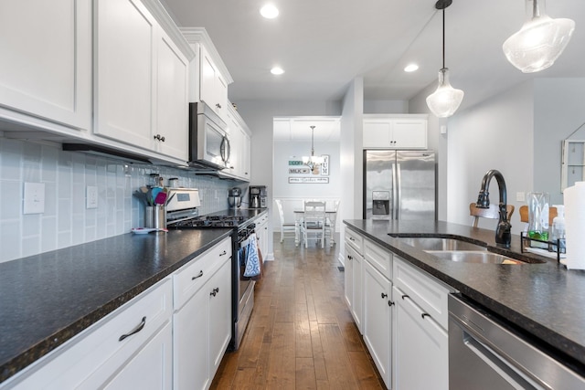 5308 Abbottswood Dr, Smyrna, TN 37167 - kitchen featuring appliances with stainless steel finishes, white cabinetry, dark wood-style flooring, recessed lighting, and tasteful backsplash