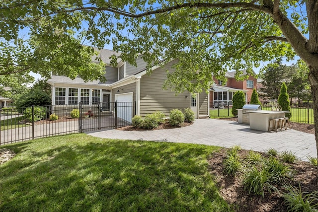 311 Wandering Cir, Franklin, TN 37067 - back of house with a garage, roof with shingles, driveway, and an outdoor kitchen