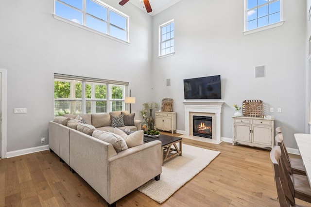 311 Wandering Cir, Franklin, TN 37067 - living area featuring a high ceiling, a ceiling fan, light wood-style floors, and a fireplace with flush hearth