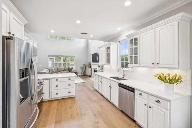 311 Wandering Cir, Franklin, TN 37067 - kitchen with stainless steel appliances, white cabinets, open floor plan, glass insert cabinets, and recessed lighting