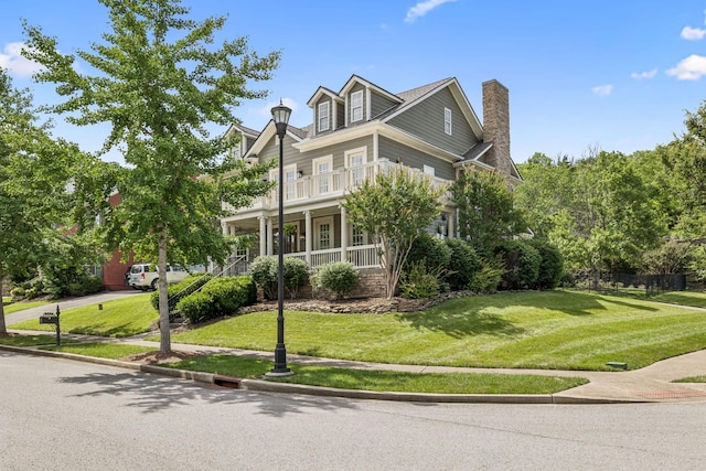 311 Wandering Cir, Franklin, TN 37067 - view of front facade featuring covered porch, a front lawn, and a chimney