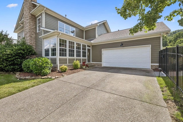 311 Wandering Cir, Franklin, TN 37067 - view of front facade with driveway, an attached garage, a chimney, and stone siding