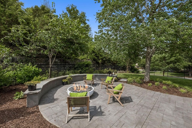 311 Wandering Cir, Franklin, TN 37067 - fenced backyard with an outdoor fire pit, a patio area, and view of wooded area