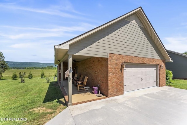 2091 Wesley Chapel Rd, Pikeville, TN 37367 - view of property exterior with a lawn, brick siding, ceiling fan, and driveway