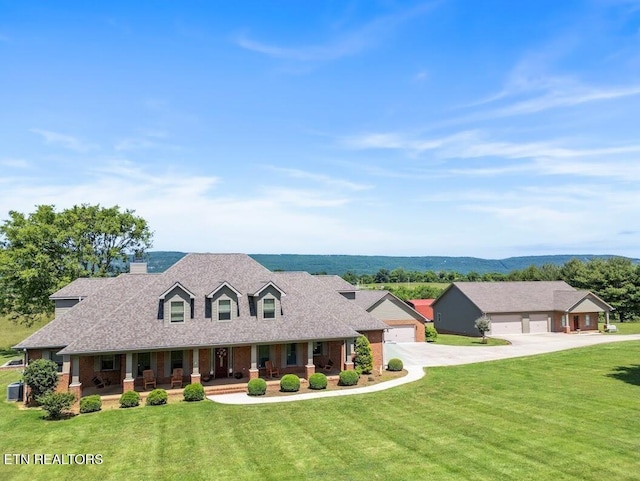 2091 Wesley Chapel Rd, Pikeville, TN 37367 - new england style home with a porch, driveway, a front yard, a chimney, and a detached garage