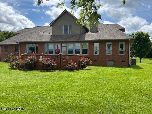 2091 Wesley Chapel Rd, Pikeville, TN 37367 - back of property with a lawn, a deck, brick siding, and a shingled roof