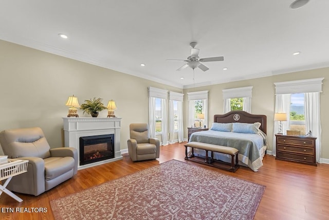 2091 Wesley Chapel Rd, Pikeville, TN 37367 - bedroom with a glass covered fireplace, wood finished floors, crown molding, ceiling fan, and recessed lighting