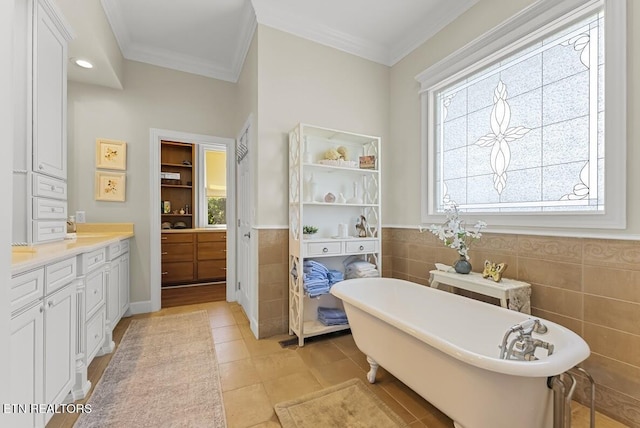 2091 Wesley Chapel Rd, Pikeville, TN 37367 - bathroom with tile walls, vanity, a freestanding tub, ornamental molding, and a wainscoted wall
