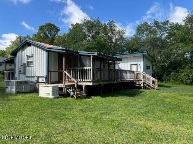 337 Bellview Rd, Pikeville, TN 37367 - rear view of house featuring a lawn, board and batten siding, and a deck