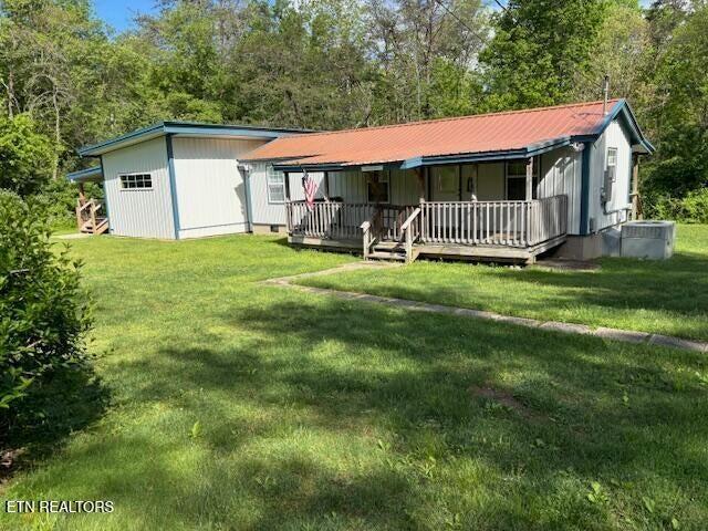 337 Bellview Rd, Pikeville, TN 37367 - view of front of home featuring a porch, a front yard, and a metal roof