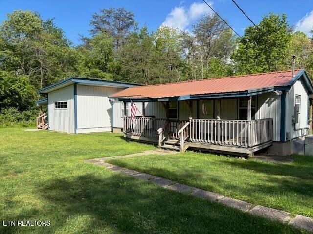 337 Bellview Rd, Pikeville, TN 37367 - back of house with covered porch, a yard, and a metal roof