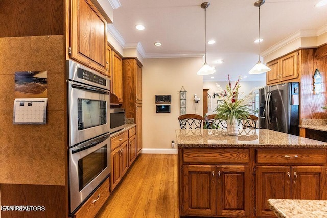 233 Nine Mile Cross Rd, Pikeville, TN 37367 - kitchen featuring stainless steel appliances, crown molding, brown cabinetry, light wood-style flooring, and a kitchen island