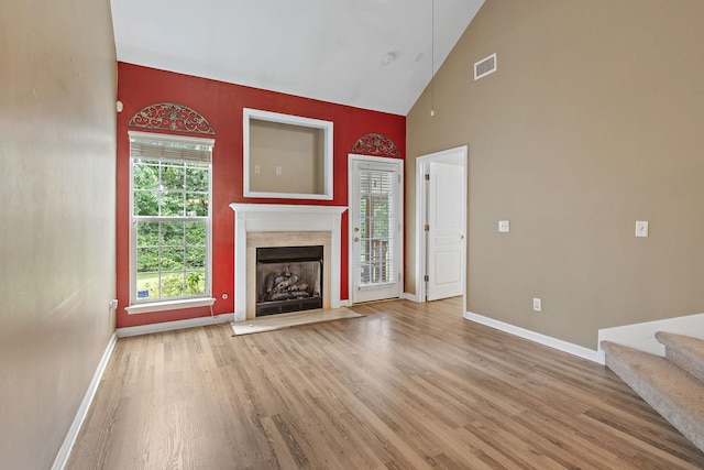 245 Northcrest Commons Cir, Nashville, TN 37211 - unfurnished living room with high vaulted ceiling, wood finished floors, a premium fireplace, and stairway
