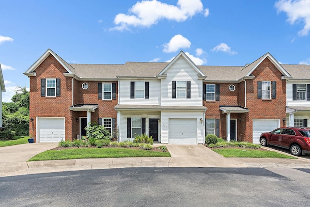 245 Northcrest Commons Cir, Nashville, TN 37211 - townhome / multi-family property featuring an attached garage, driveway, and brick siding