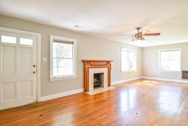 1204 Rolling Fields Dr, Columbia, TN 38401 - unfurnished living room with ceiling fan, wood finished floors, and a tiled fireplace