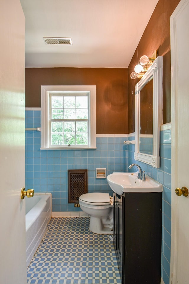 1204 Rolling Fields Dr, Columbia, TN 38401 - bathroom with tile walls, vanity, tile patterned floors, heating unit, and a wainscoted wall