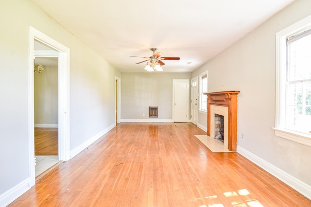 1204 Rolling Fields Dr, Columbia, TN 38401 - unfurnished living room featuring a tiled fireplace, light wood finished floors, and ceiling fan