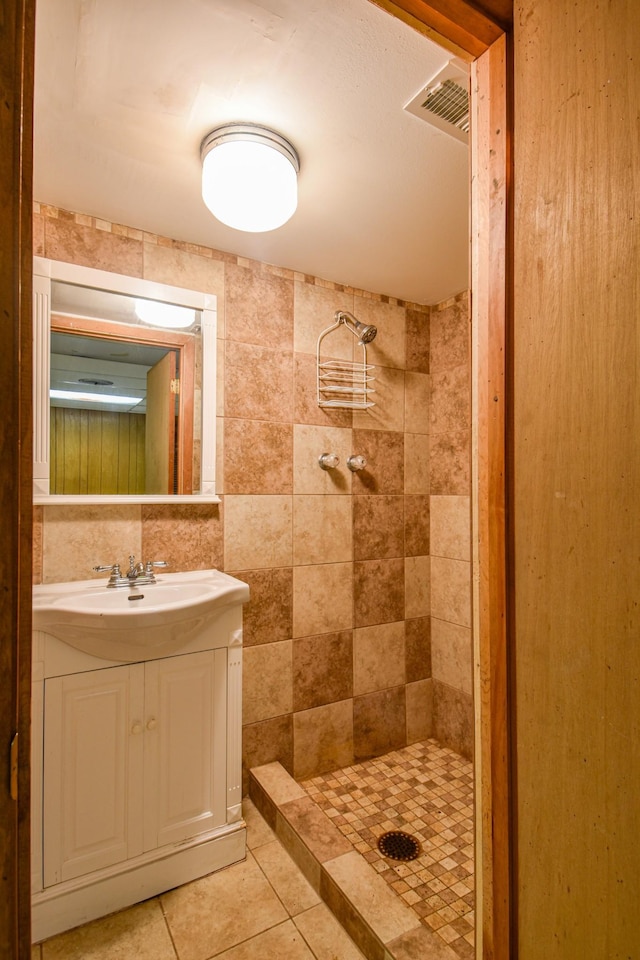1204 Rolling Fields Dr, Columbia, TN 38401 - full bathroom with a stall shower, vanity, tile patterned floors, and tile walls