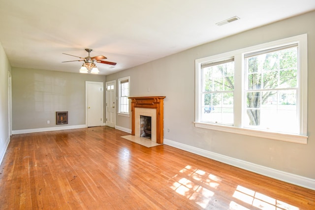 1204 Rolling Fields Dr, Columbia, TN 38401 - unfurnished living room with a fireplace with flush hearth, light wood-style floors, and ceiling fan